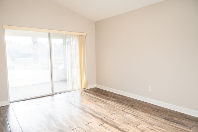 unfurnished room with lofted ceiling