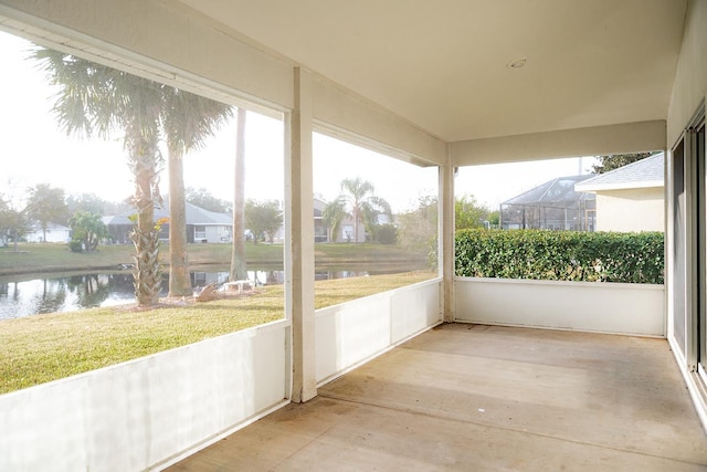 unfurnished sunroom with a water view and a healthy amount of sunlight