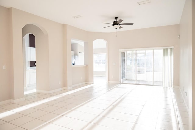 empty room with light tile patterned floors and ceiling fan