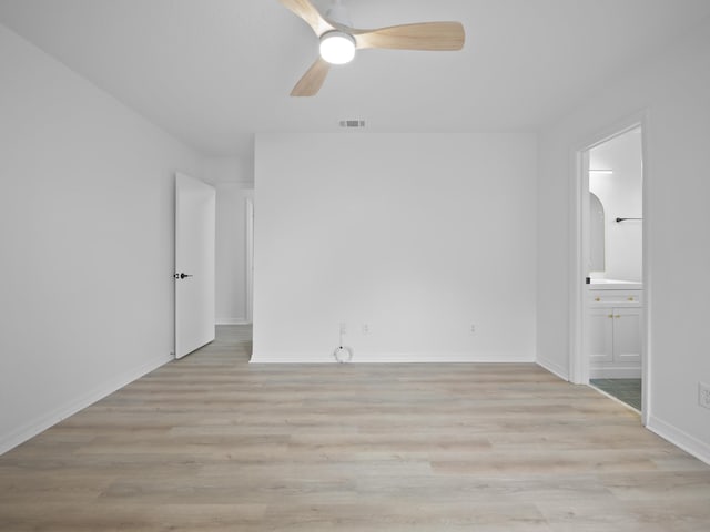 unfurnished bedroom featuring connected bathroom, light hardwood / wood-style floors, and ceiling fan