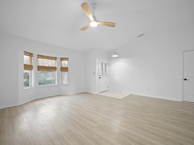 spare room featuring vaulted ceiling, light hardwood / wood-style floors, and ceiling fan