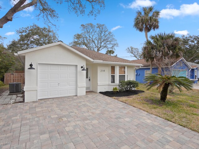 rear view of property featuring stucco siding, a fenced backyard, and a deck