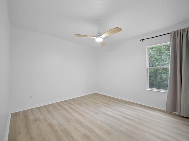 empty room with light hardwood / wood-style flooring and ceiling fan