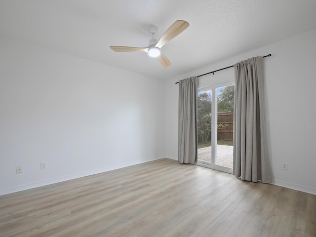 spare room with a textured ceiling, ceiling fan, and light hardwood / wood-style flooring