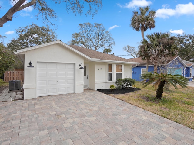 ranch-style house with a garage and central AC