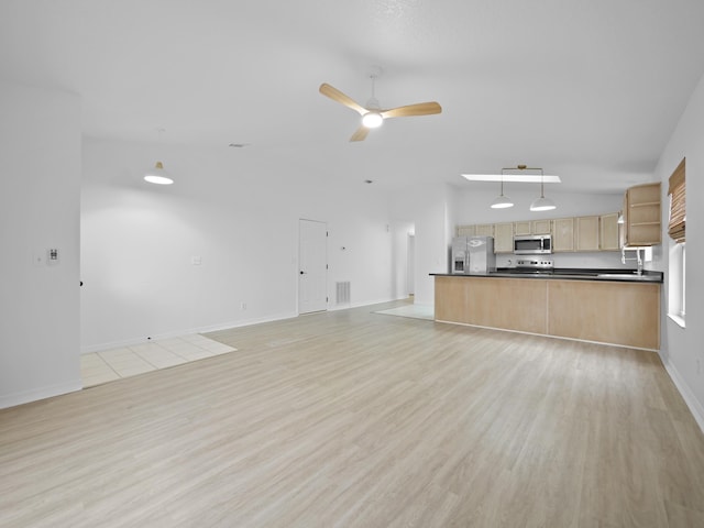 unfurnished living room featuring vaulted ceiling, light hardwood / wood-style floors, and ceiling fan