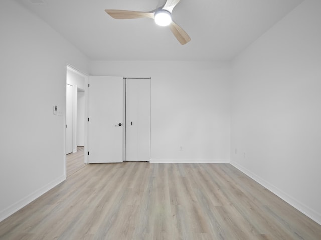 unfurnished bedroom with ceiling fan, light hardwood / wood-style floors, and a closet