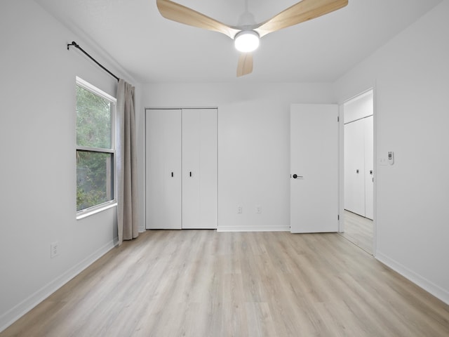 unfurnished bedroom featuring ceiling fan, light wood-type flooring, and a closet