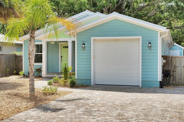 403 Second St, Saint Augustine, FL 32084 - view of front of house with fence, decorative driveway, and a garage