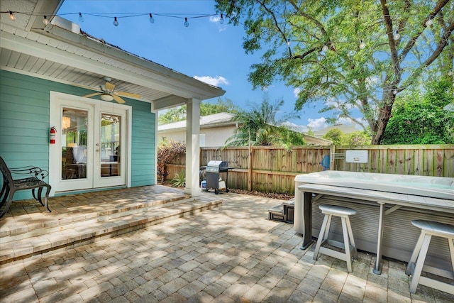 403 Second St, Saint Augustine, FL 32084 - view of patio with a fenced backyard, a grill, a ceiling fan, a hot tub, and french doors
