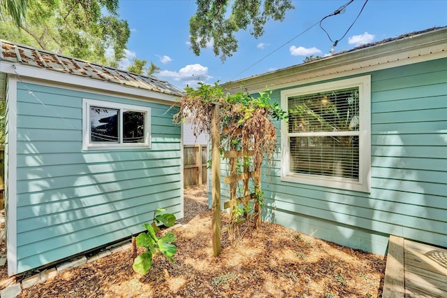 403 Second St, Saint Augustine, FL 32084 - view of side of property featuring fence, an outbuilding, and metal roof