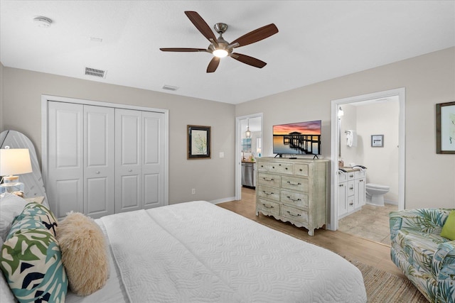 403 Second St, Saint Augustine, FL 32084 - bedroom featuring ensuite bath, light wood-style floors, a closet, baseboards, and a ceiling fan