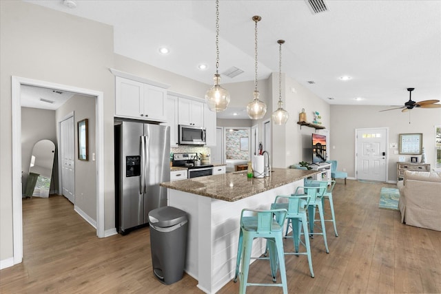 403 Second St, Saint Augustine, FL 32084 - kitchen with white cabinetry, appliances with stainless steel finishes, visible vents, open floor plan, and light wood-type flooring