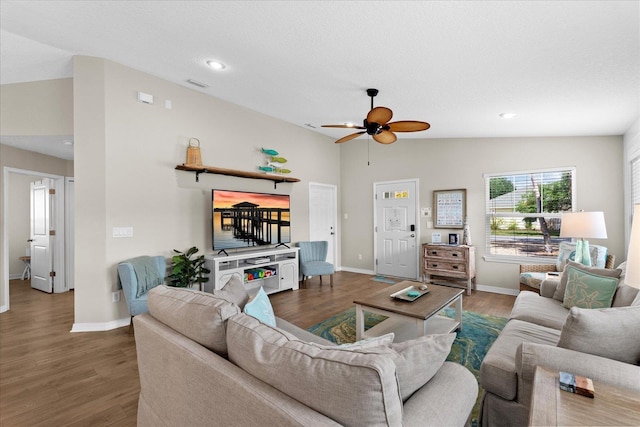 403 Second St, Saint Augustine, FL 32084 - living area with visible vents, baseboards, vaulted ceiling, wood finished floors, and a ceiling fan