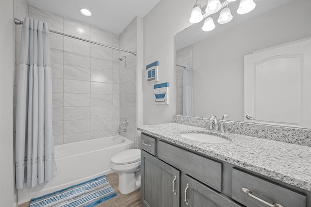 full bathroom with hardwood / wood-style flooring, vanity, toilet, and shower / bathtub combination with curtain