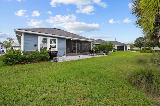 back of house with a sunroom, a yard, and a patio