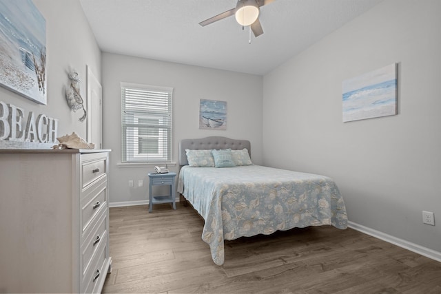 bedroom with ceiling fan and dark hardwood / wood-style flooring