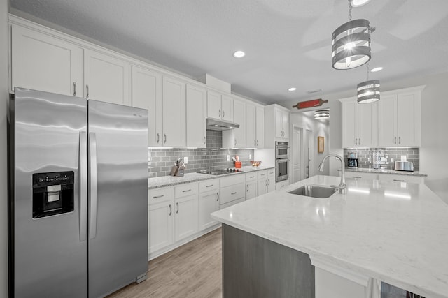 kitchen featuring hanging light fixtures, sink, white cabinets, and stainless steel appliances