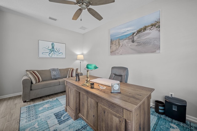 office space with ceiling fan and light hardwood / wood-style floors