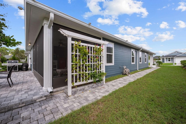 view of property exterior featuring a patio area and a lawn