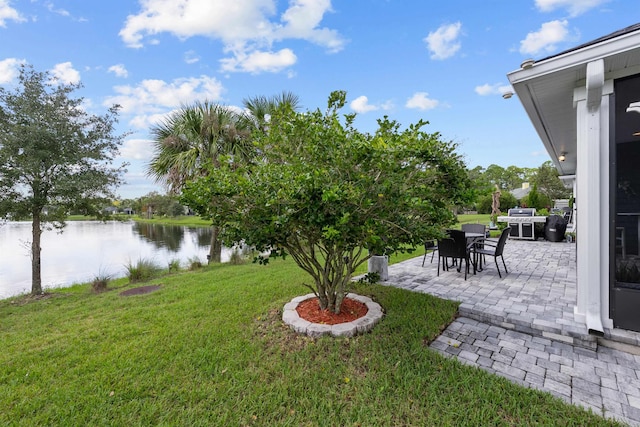 view of yard featuring a patio area and a water view