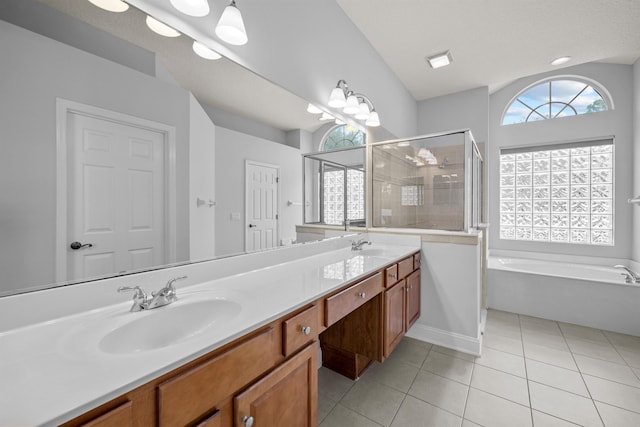 bathroom featuring shower with separate bathtub, tile patterned floors, and vanity