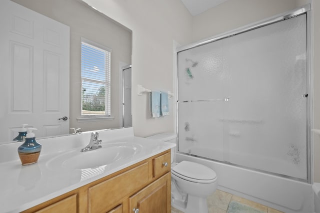 full bathroom with vanity, tile patterned flooring, toilet, and combined bath / shower with glass door