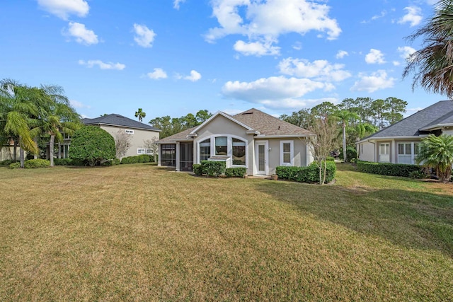 ranch-style home with a sunroom and a front yard