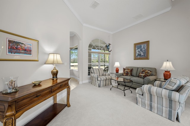 living room featuring light carpet, a towering ceiling, and ornamental molding