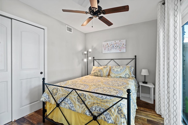 bedroom with a closet, ceiling fan, and dark wood-type flooring