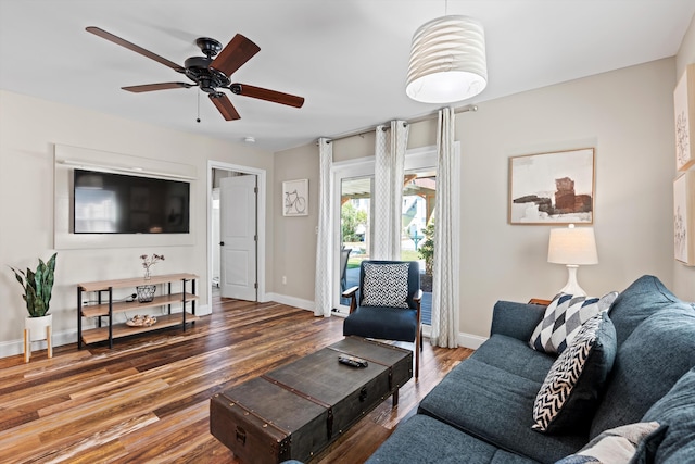 living room featuring hardwood / wood-style flooring and ceiling fan