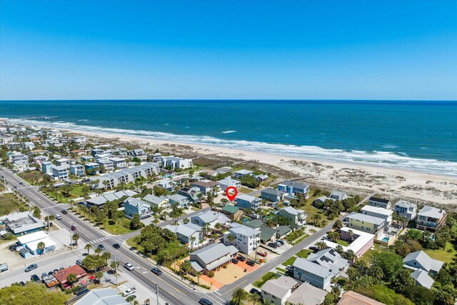 birds eye view of property featuring a water view and a view of the beach