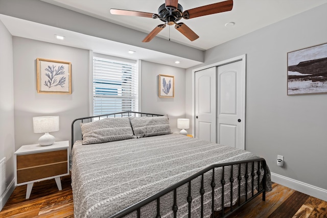 bedroom with hardwood / wood-style floors, a closet, and ceiling fan