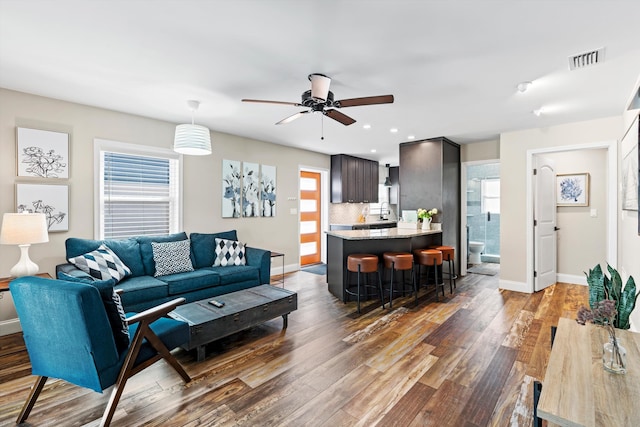 living room featuring dark hardwood / wood-style floors and ceiling fan