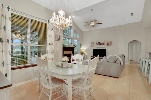 tiled dining room featuring ceiling fan and high vaulted ceiling