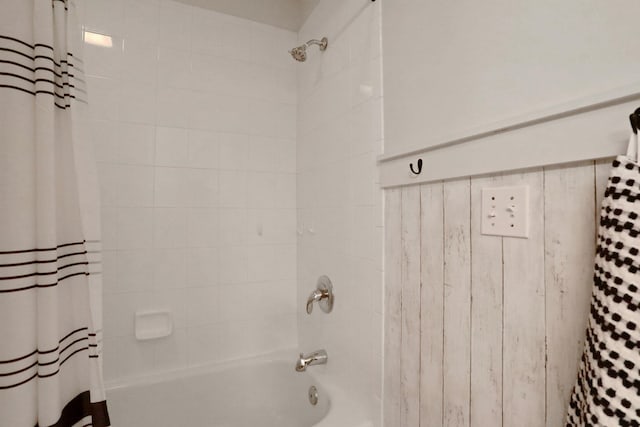 bathroom with shower / bath combo with shower curtain