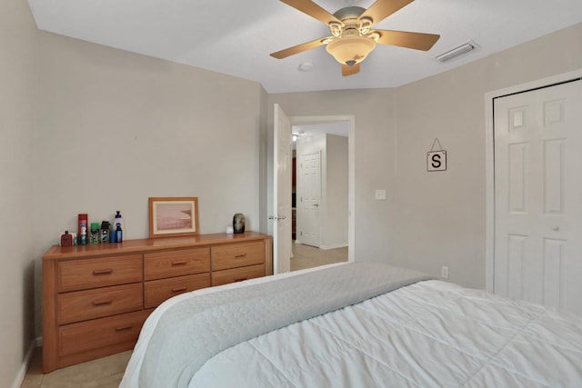 tiled bedroom with ceiling fan