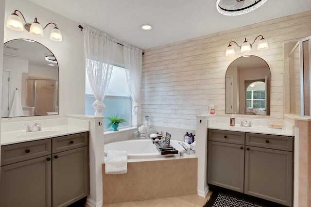 bathroom featuring vanity, shower with separate bathtub, tile patterned floors, and wood walls