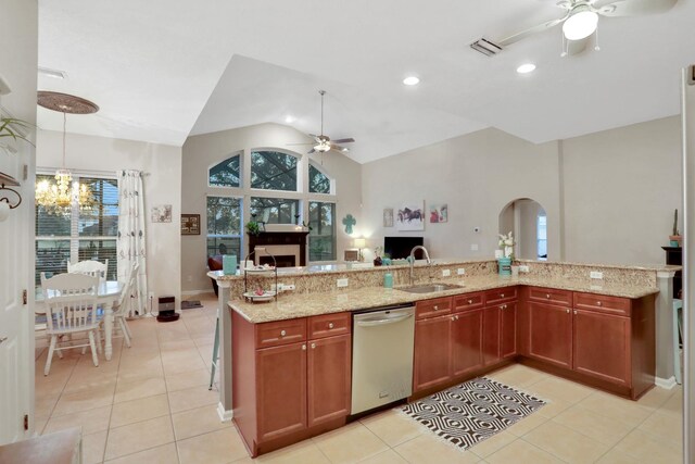 kitchen featuring sink, hanging light fixtures, dishwasher, light stone countertops, and ceiling fan with notable chandelier