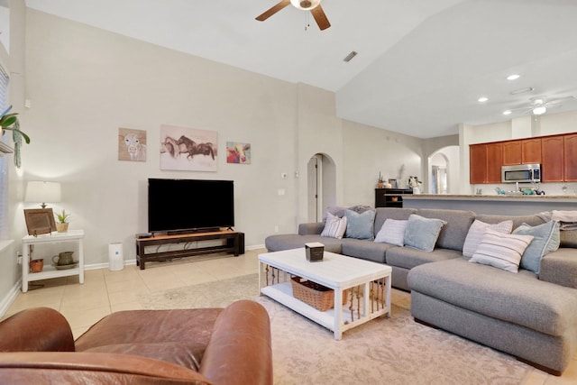 living room featuring high vaulted ceiling, light tile patterned floors, and ceiling fan