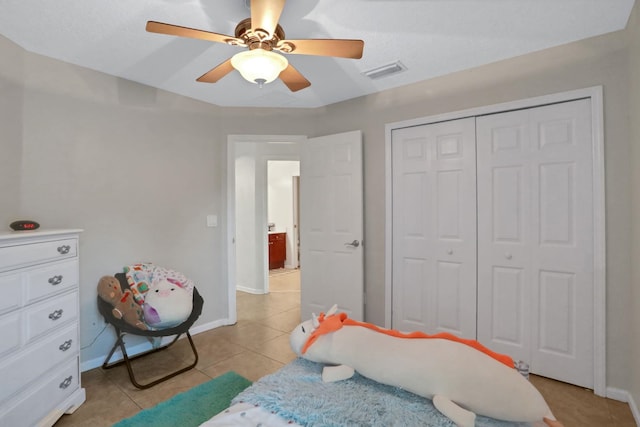 tiled bedroom featuring a closet and ceiling fan