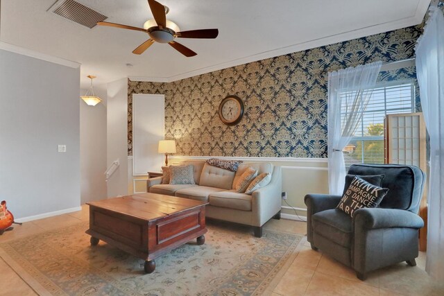 tiled living room featuring crown molding and ceiling fan