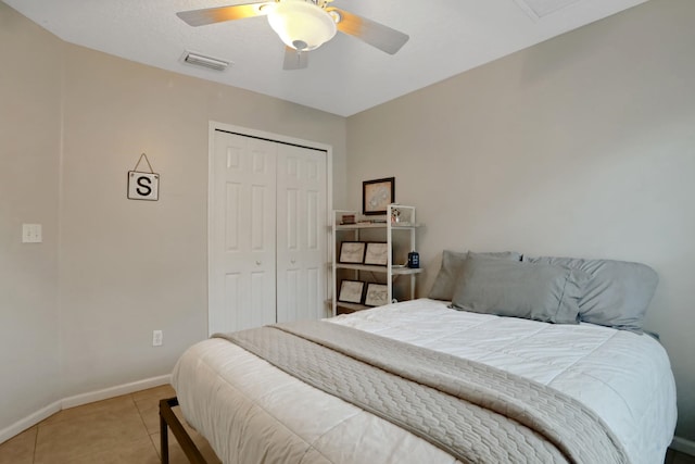 bedroom with light tile patterned floors, ceiling fan, and a closet