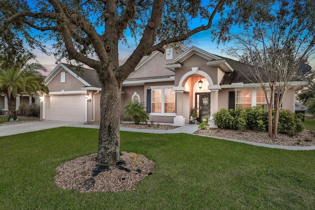 single story home featuring a garage and a yard