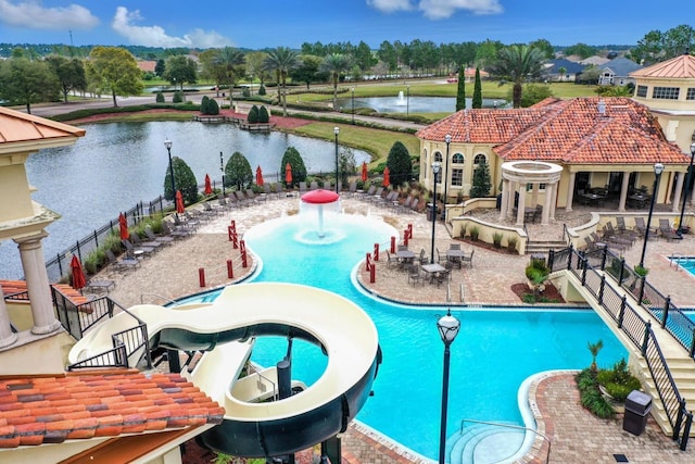 view of swimming pool with a water view and a water slide