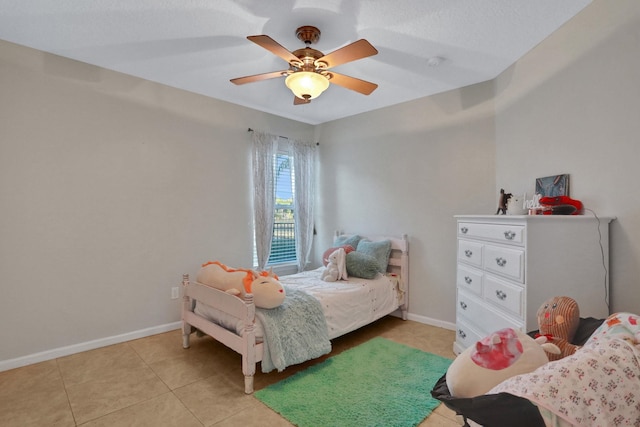 bedroom featuring light tile patterned floors and ceiling fan