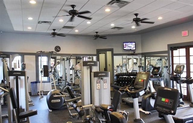 exercise room featuring ceiling fan and a paneled ceiling