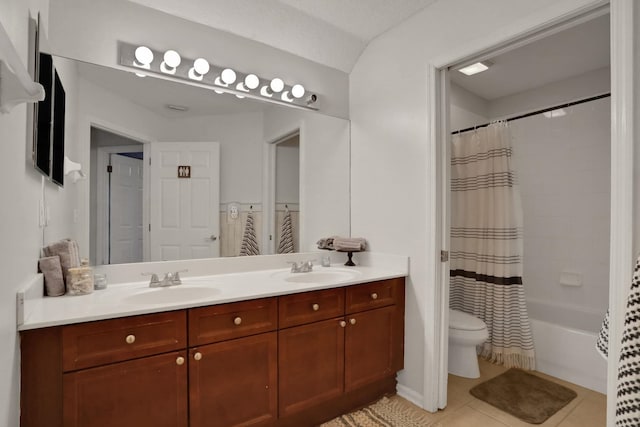 full bathroom featuring shower / bath combo, vanity, tile patterned floors, and toilet