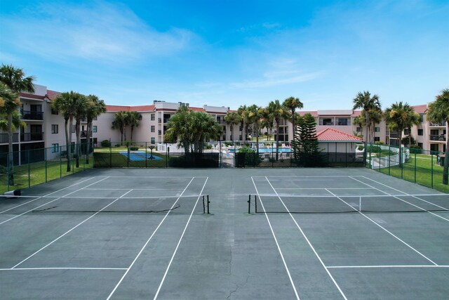 view of sport court featuring fence