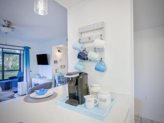 bathroom featuring ceiling fan and tile patterned flooring